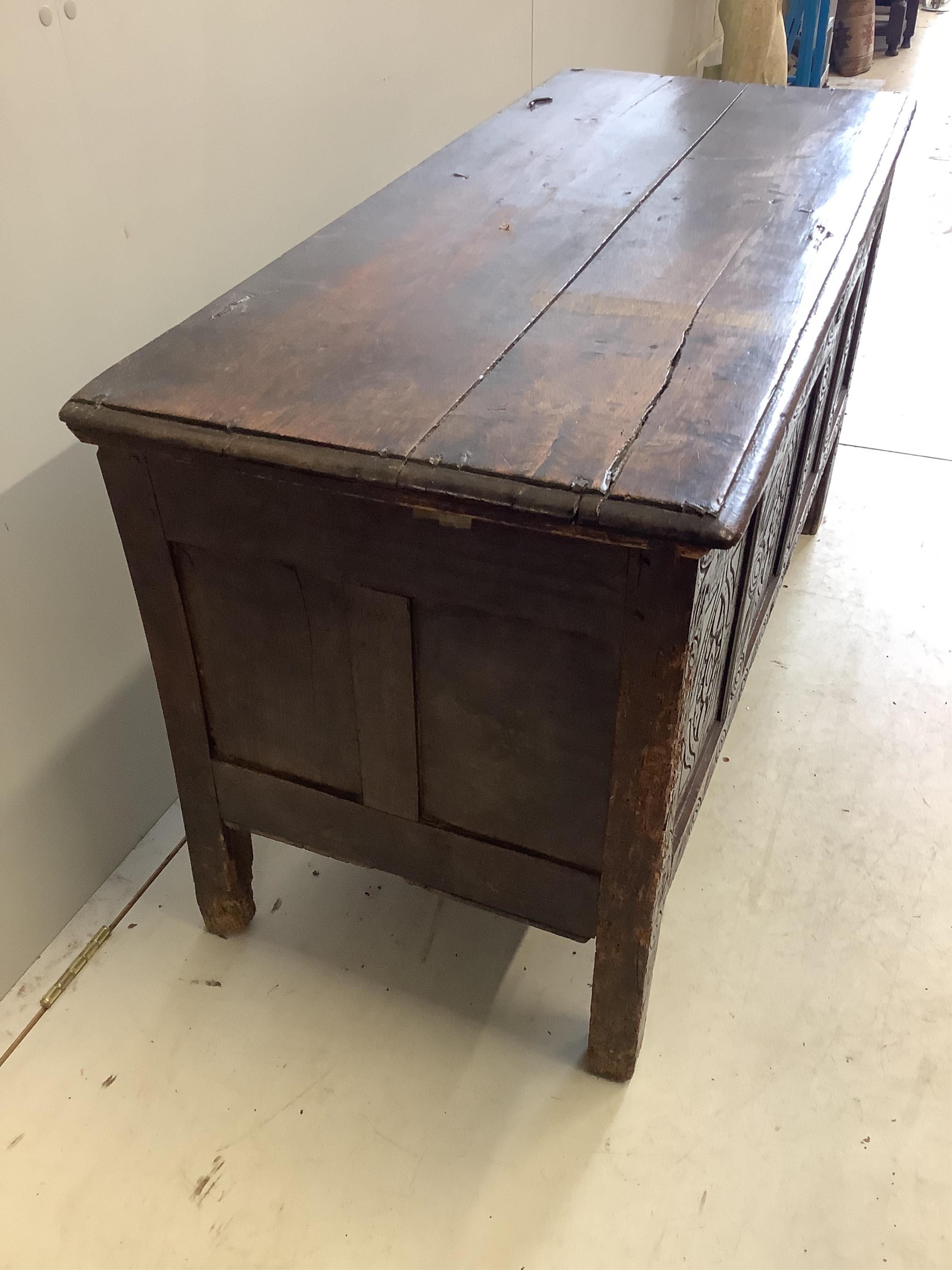 An 18th century carved oak coffer, width 125cm, depth 53cm, height 68cm. Condition - poor